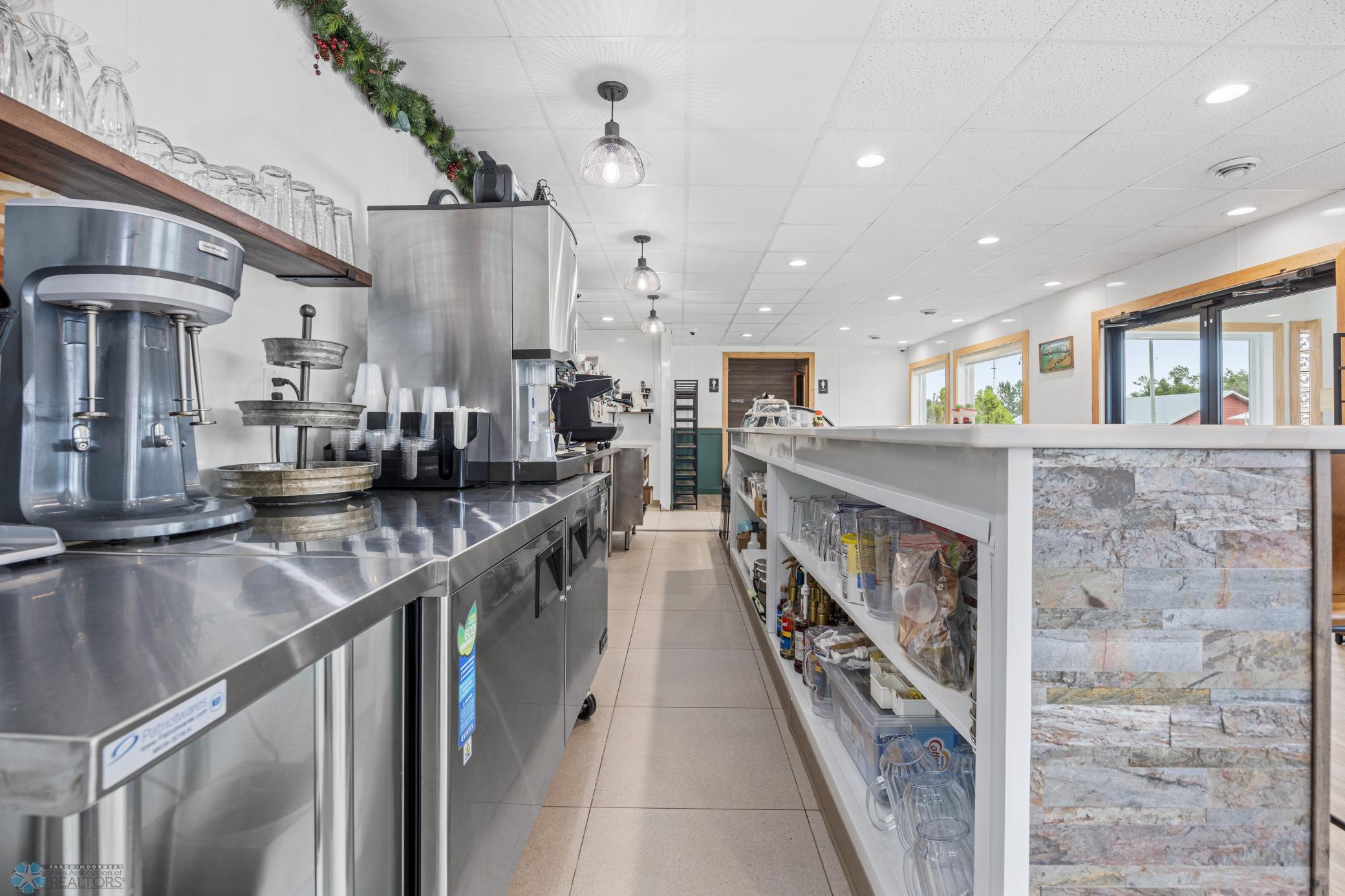 Front bar area stocked with supplies, espresso & coffee machine