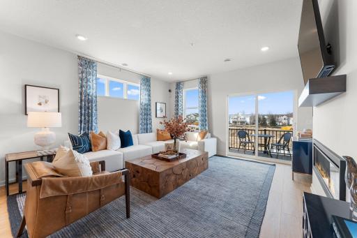 Anchored by a modern electric fireplace and accented by the warmth of the floors, high ceilings, and large windows, the family room is a great place to gather!