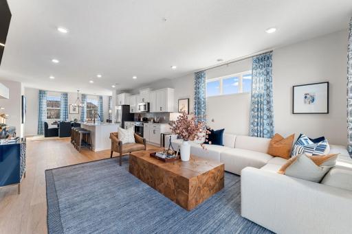 The open concept layout with luxury vinyl plank floors seamlessly connects the main living areas.