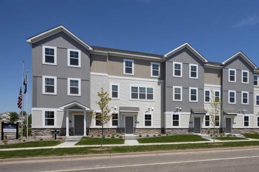 The end unit exterior has striking curb appeal with it's modern design, highlighted by stone accents & clean architectural lines. A charming front patio offers the perfect spot to relax, while the expansive windows fill the home with natural light.
