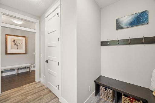 Mud room entry from the garage with large storage closet and bench seats