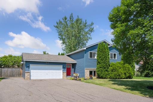 Spacious driveway and charming landscaping