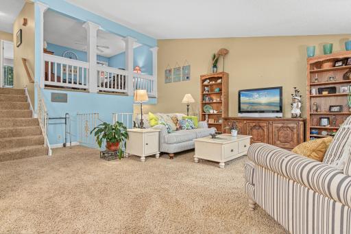 Vaulted main floor living room with loft overlooking the area