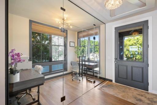 Bright and modern glass-enclosed office space featuring large windows, rich natural light, and direct outdoor access—perfect for remote work or creative pursuits.