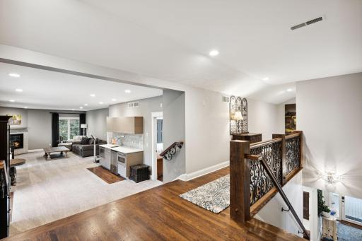 The open layout flows into the upper level, featuring a spacious living room with wet barâperfect for entertaining. Once a private apartment above the garage, this area has been seamlessly integrated into the homeâs luxury design.