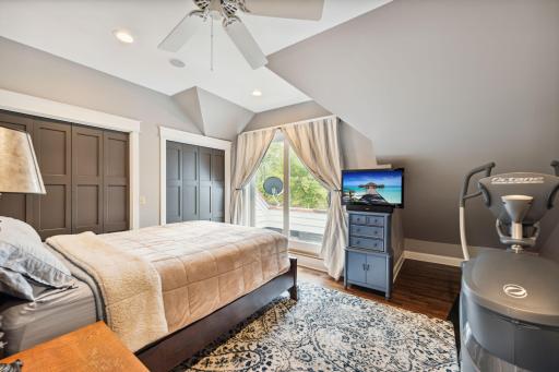 This fourth upper-level bedroom features hardwood floors, ample closet space, and its own private balcony.