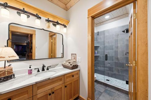 Remodeled in 2023, the lower-level Â¾ bath features a spacious tile walk-in shower, separate toilet room, and updated finishes throughout.