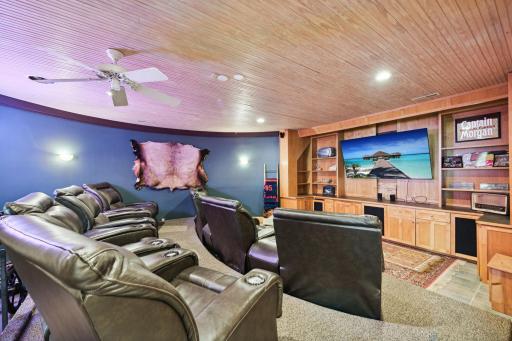 Enjoy a true home theater experience in this custom-designed media room, featuring tiered seating and built-in cabinetry for your entertainment center. Perfect for movie nights or game day gatherings.