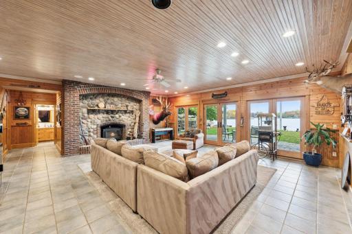 Anchored by a stunning wood-burning fireplace with stone and brick surround, this lower-level space brings cozy âup northâ charm to lakeside living.