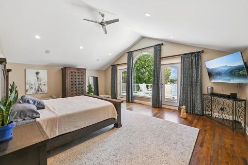 The spacious primary suite offers nearly 800 sq ft with vaulted ceilings, stunning lake views, a walk-through closet, and a luxurious spa-like bath with separate tub and shower.