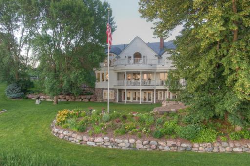 Surrounded by mature trees, lush perennial gardens, and boulder-lined landscaping, this beautifully maintained property feels like your own private lakeside park.