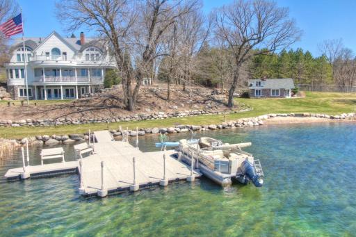 Iconic West Lake Sylvia estate featuring nearly 400 feet of shoreline, private docks, tiered gardens, and a charming guest cottage all with golf cart access and no steps to the water. A rare blend of luxury and lakeside ease.