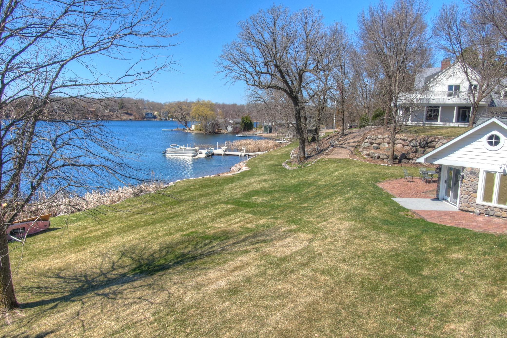 A charming brick patio wraps around the guest cottage with panoramic views of Lake Sylvia. The perfect spot for outdoor dining, morning coffee, or sunset relaxation just steps from the shoreline in this exceptional lakeshore retreat.