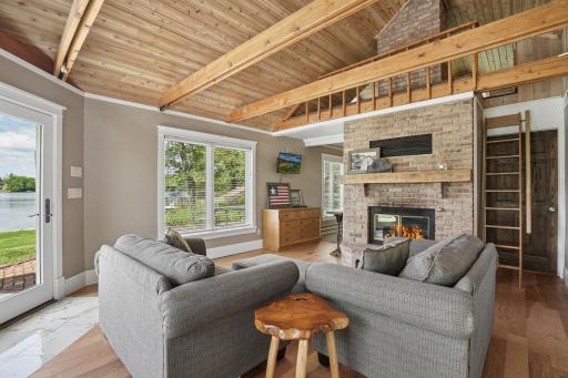 Beautifully finished guest house featuring vaulted wood-beamed ceilings, a cozy brick wood burning fireplace, and lake views from every window. A private loft creates a welcoming retreat for guests in this one-of-a-kind lakeshore estate.