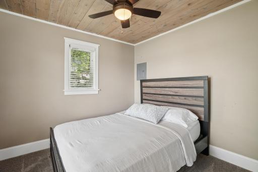 The guest cottage bedroom offers phenomenal views looking out over West Lake Sylvia. This building has its own furnace/ac, water heater and softener along with baseboard electric & the fireplace as supplemental heat sources.