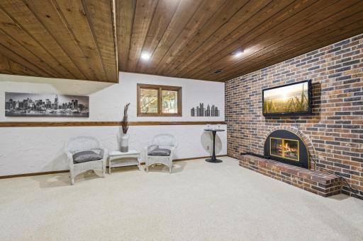Lower level family room with brick gas fireplace