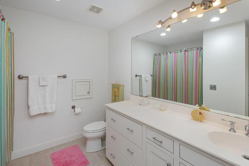 This private en suite bathroom, connected to the second bedroom, features a full layout designed for comfort and convenience. Whether for guests, teens, or extended family, it offers a seamless blend of function, privacy, and style.