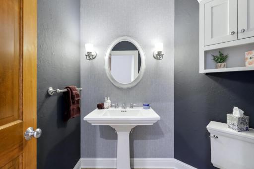 Conveniently located near the front entrance and adjacent to the home office, the main floor powder room is tastefully appointed with refined finishes.