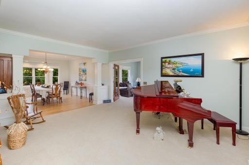 As you step inside, the home unfolds with gracious charm. To your right, the spacious living room beckonsâbathed in natural light and designed for both comfort and connection. French doors frame the sunroom, offering a tranquil retreat.
