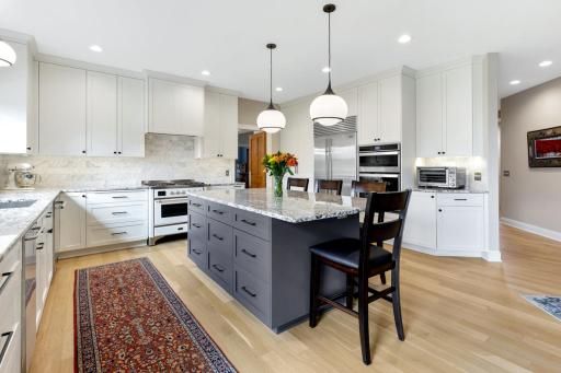 Thoughtfully renovated in 2022, this gourmet kitchen shines with all-new custom cabinetry, a striking marble backsplash, and rich granite countertops. At its center, a generous 7-foot island serves as a natural hub for entertaining.