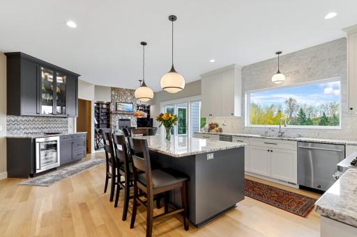 From the formal dining room, enjoy a seamless view into the gourmet kitchenâdesigned for both function and flairâand beyond to the soaring two-story family room, where vaulted ceilings and natural light create a sense of openness and connection.