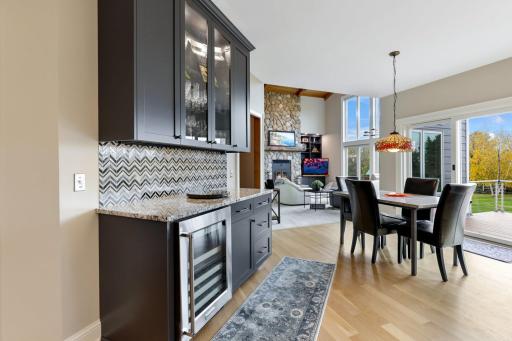 Enjoy a seamless transition to the backyard deckâideal for al fresco dining and relaxationâwhile just beyond, the soaring two-story family room opens up with expansive volume and natural light, creating a blend of indoor comfort and outdoor charm.