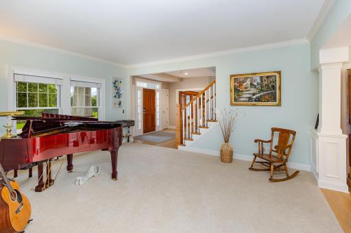 From the sunroom, enjoy a picturesque view through the living room toward the grand front entry.