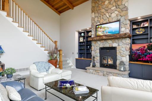 Anchoring the room is a grand stone wood-burning fireplace, adorned with a handcrafted solid pine mantelâan artisan piece thoughtfully designed by a local sawmill craftsman.