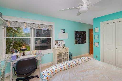 The second bedroom offers serene views of the private backyard, creating a bright and peaceful retreat.