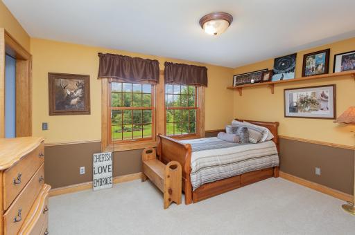 The third bedroom welcomes soft northern light through its windows and features convenient access to a full Jack and Jill bathroom, shared with the adjacent fourth bedroom.