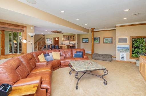Designed for connection and comfort, this expansive gathering area invites movie nights, game day excitement, and memorable celebrations. With generous proportions and seamless flow to the adjacent bar and patio.