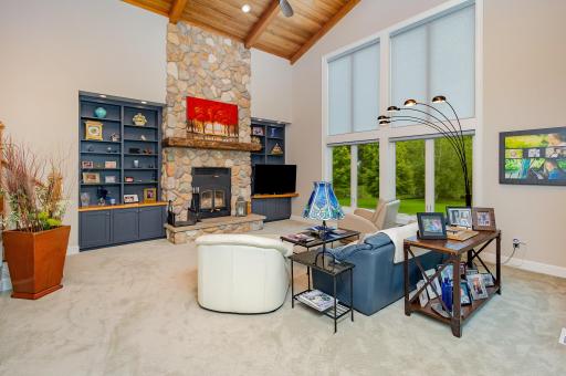 Just off the kitchen, the breathtaking two-story family room showcases brand new Anderson windows that flood the space with natural light. Power shades add effortless comfort, making this space as functional as it is inviting.