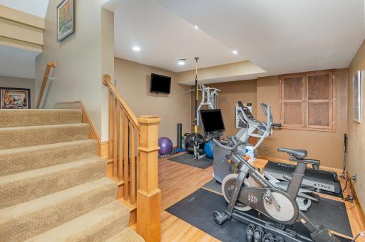 Just off the split staircase in the lower level, you'll find a 13x14 open workout spaceâperfectly sized for fitness, wellness, or even a quiet yoga retreat. Its location offers easy access while maintaining enough separation for focused routines.