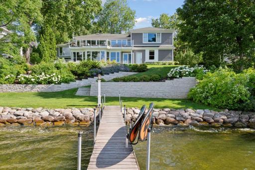 This timeless Nantucket-style home offers 82 ft of lakeshore on Crystal Bay.