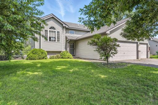 Charming split-level home with a three-car garage, mature trees, and a fully fenced backyard. Crisp curb appeal with vinyl siding, updated roof (2022), gutters and a welcoming front entry.