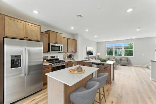 Offering timeless finishes that blend an elevated feel with functionality. The L-shaped kitchen with island and adjacent dining area make a perfect space for both everyday meals and entertaining.