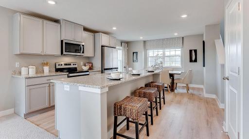 Beautiful high end kitchen with plenty of space to move around and entertain. Model picture shown. Colors and finishes may vary. Subject address is an interior unit. Exterior unit photos shown.