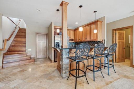 Lower Level Wet Bar is great for entertaining. This open concept lower level is perfect for hosting football games this fall. And it walks right out to the lower level patio.