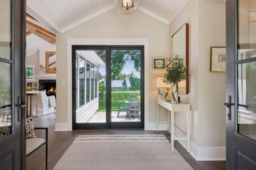 Foyer with view through sliding glass door to backyard