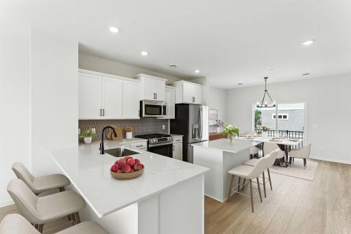 Light and bright! The finishes blend an elevated feel with functionality. The L-shaped kitchen with island and adjacent dining area make a perfect space for both everyday meals and entertaining.