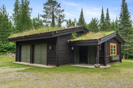 The Custom built garage is oversized, heated, completely finished and has a separate workshop, featuring an authentic sod roof (12 inches deep) with natural grass growth, copper scuppers for drainage and traditional construction methods.