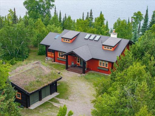 Steel maintenance free roof with sky lights on the main home and an authentic grass roof on the garage.