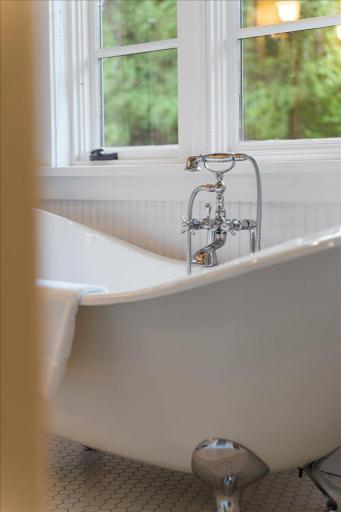 This authentic french soaking tub and its custom plumbing fixtures set the stage like a fine piece of jewelry.