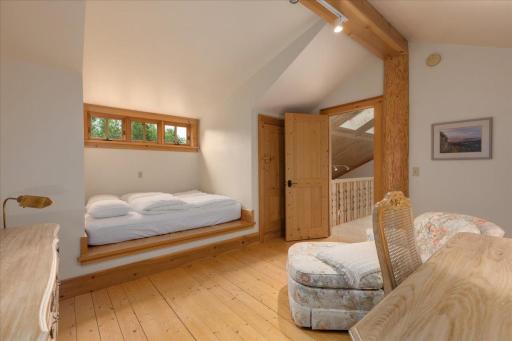 Another bedroom with a Swedish bunk, piano windows and French doors make this a favorite space. The storage behind these doors is endless.
