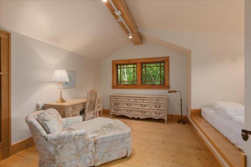 Another room that is expansive with a vault and expansive closets.