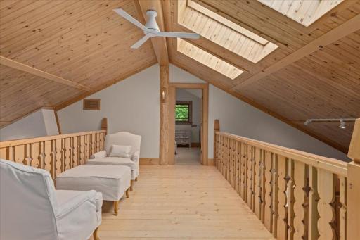 Hand-carved Norwegian woodwork and custom splats make this loft space a fabulous place to entertain, play games and hang out.