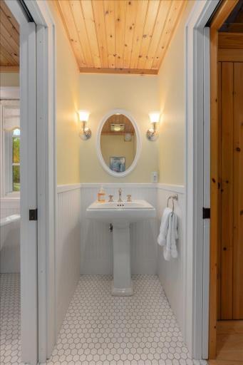 Pocket doors flank either side of the water closet and vanity so guests have a perfectly convenient guest bath on the main level.