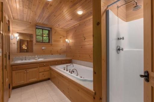 The lower level bath is connected to the Sauna and offers a whirlpool tub, custom cabinetry and a walk in shower.