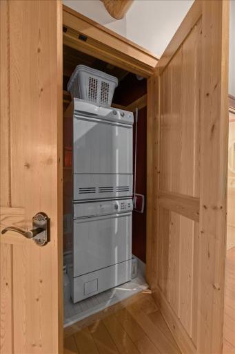 There are two laundry rooms in the house. This stackable is off the Living room - Primary Suite Hall on the main level