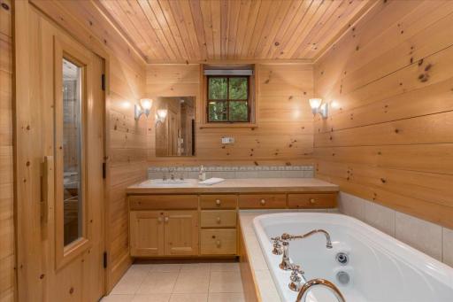 The lower level bath even has a custom door window and the trees are beyond moving with the breeze.